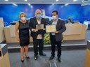 Dr. Carlos Mosconi(centro) recebe placa comemorativa e diploma entregues pela Ver. Regina Cioffi e Ver. Marcelo Heitor da Silva.